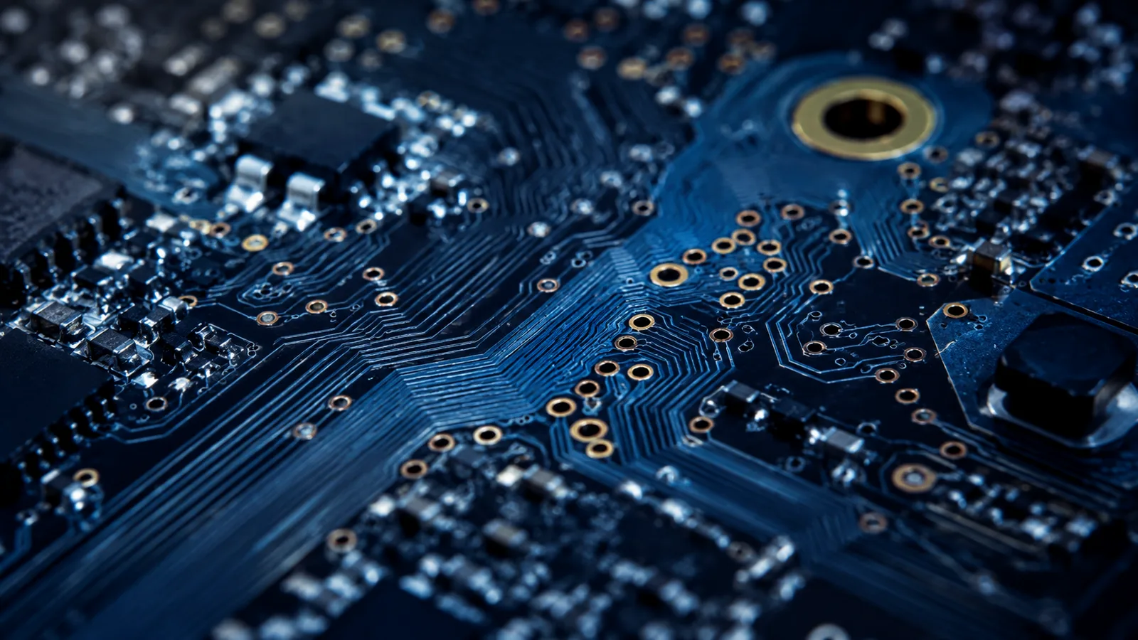 Macro photograph of BGA escape routing on a navy printed circuit board